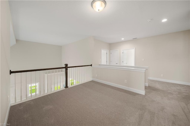 carpeted spare room with baseboards and recessed lighting