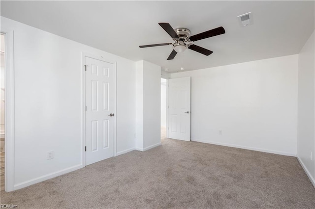 unfurnished bedroom with carpet, baseboards, ceiling fan, and visible vents