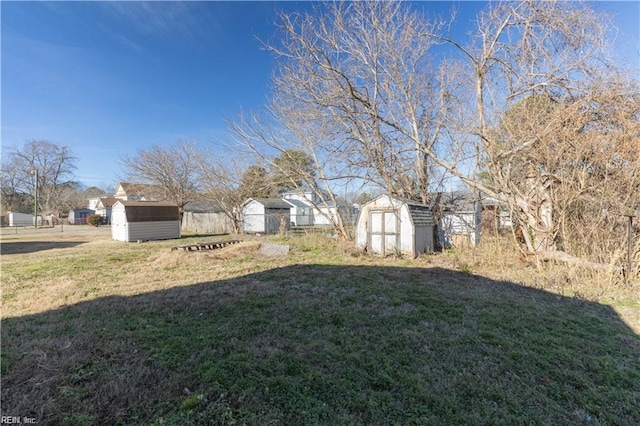 view of yard featuring an outbuilding and a storage unit