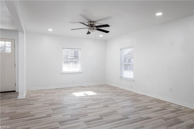 unfurnished room with plenty of natural light, visible vents, and recessed lighting