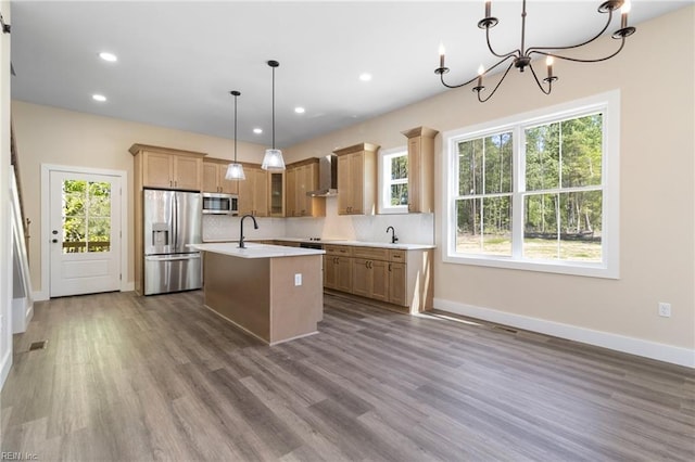 kitchen with light countertops, wall chimney exhaust hood, dark wood-style flooring, and stainless steel appliances