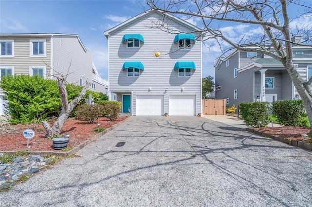 832 Surfside Ave, Virginia Beach, VA 23451 - view of front of home with a gate, a garage, and aphalt driveway