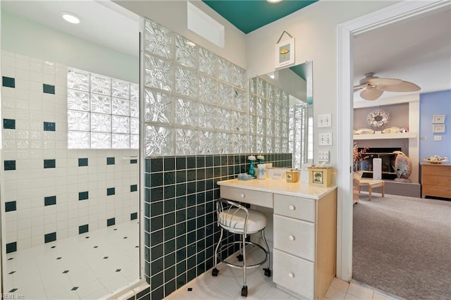 832 Surfside Ave, Virginia Beach, VA 23451 - full bathroom with tile walls, ceiling fan, a fireplace, tile patterned floors, and tiled shower