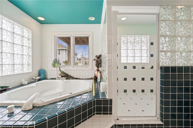 832 Surfside Ave, Virginia Beach, VA 23451 - bathroom featuring a whirlpool tub, tile walls, and a tile shower