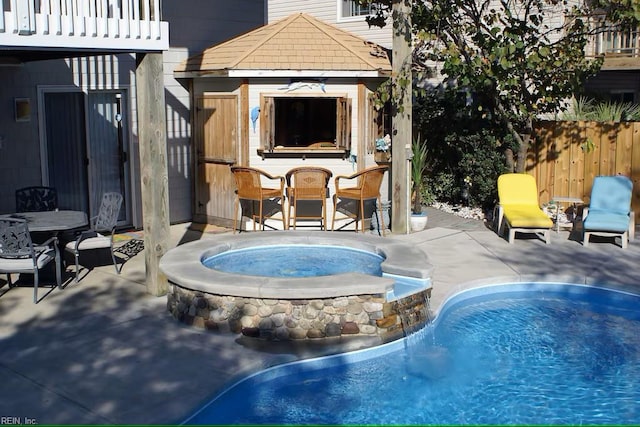832 Surfside Ave, Virginia Beach, VA 23451 - pool featuring an in ground hot tub, a patio area, a fireplace, fence, and outdoor dry bar