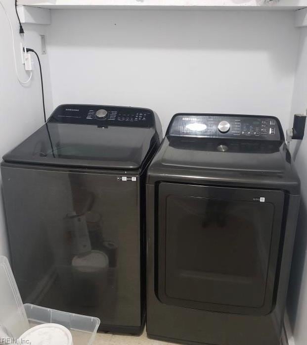 clothes washing area with laundry area and washer and clothes dryer
