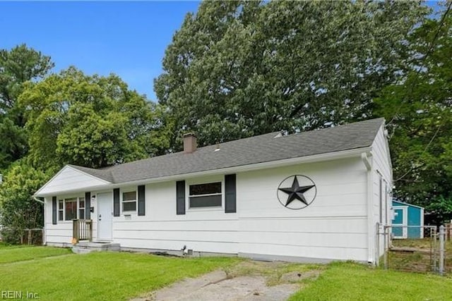 single story home with a chimney, a front yard, fence, and roof with shingles