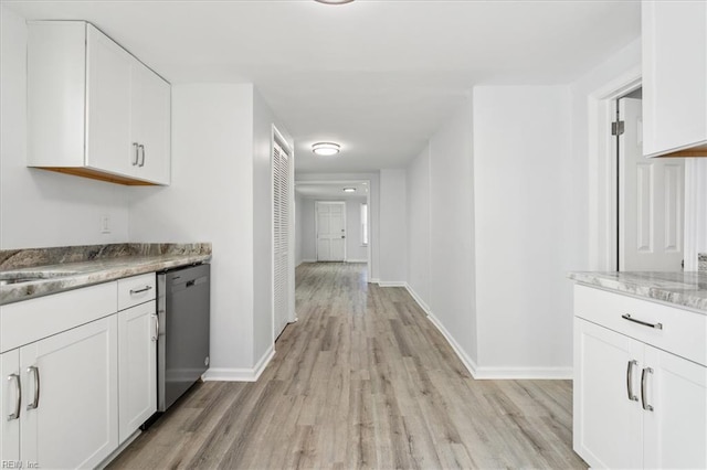 interior space with white cabinets, stainless steel dishwasher, and light wood-type flooring