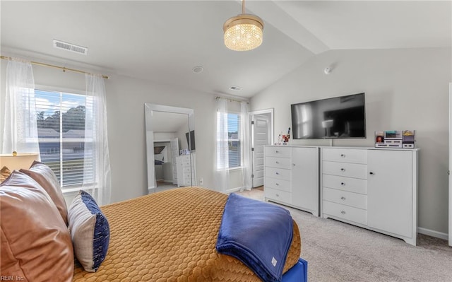 bedroom featuring visible vents, vaulted ceiling, and light carpet