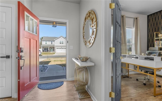 entrance foyer with baseboards and wood finished floors
