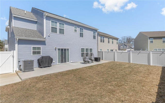 back of property featuring cooling unit, a patio, a fenced backyard, a gate, and a yard