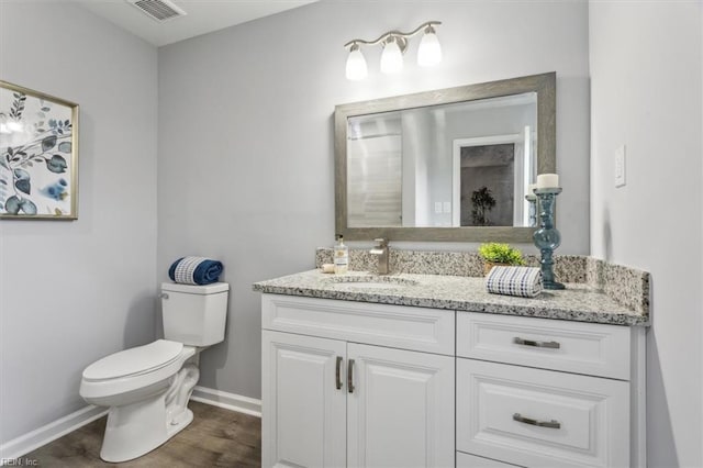 bathroom with baseboards, visible vents, toilet, and vanity