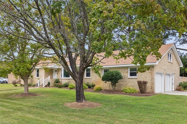 ranch-style house with brick siding, concrete driveway, and a front lawn