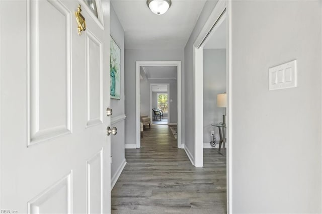 entryway featuring baseboards and wood finished floors
