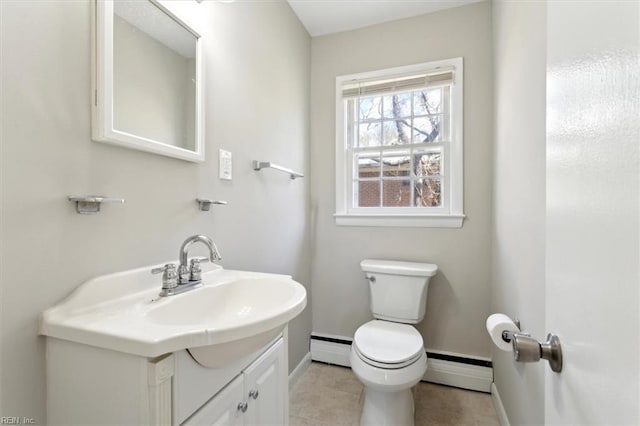 bathroom with baseboards, toilet, vanity, baseboard heating, and a baseboard heating unit