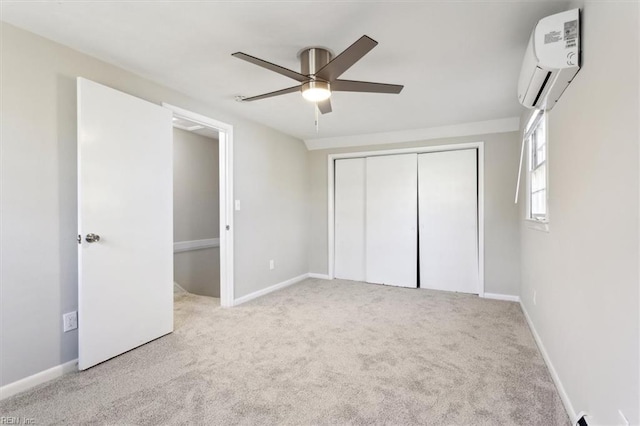 unfurnished bedroom featuring a closet, an AC wall unit, carpet, and baseboards