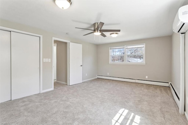 unfurnished bedroom featuring a wall mounted AC, a closet, carpet floors, and baseboard heating