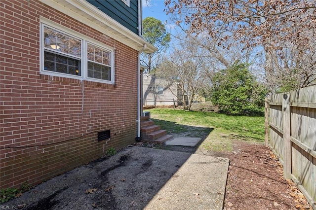 view of yard featuring fence and entry steps