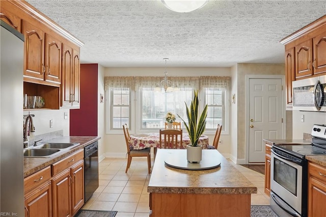 421 Richneck Rd, Newport News, VA 23608 - kitchen with a kitchen island, a sink, appliances with stainless steel finishes, and brown cabinetry