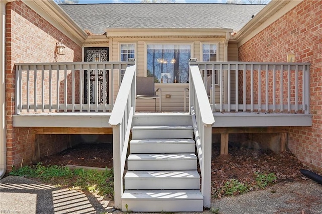 421 Richneck Rd, Newport News, VA 23608 - doorway to property featuring a deck, brick siding, and roof with shingles