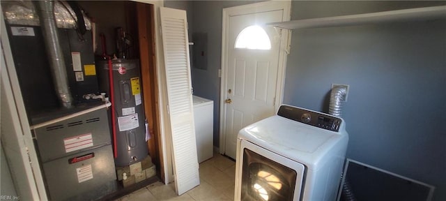 1116 Faubus Dr, Newport News, VA 23605 - washroom with electric water heater, washer and dryer, laundry area, and light tile patterned floors