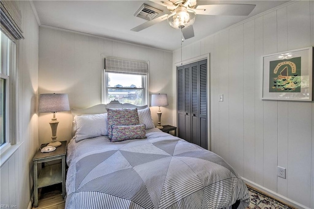 38 Callis Ln, Deltaville, VA 23043 - bedroom featuring a closet, visible vents, a ceiling fan, and wood finished floors
