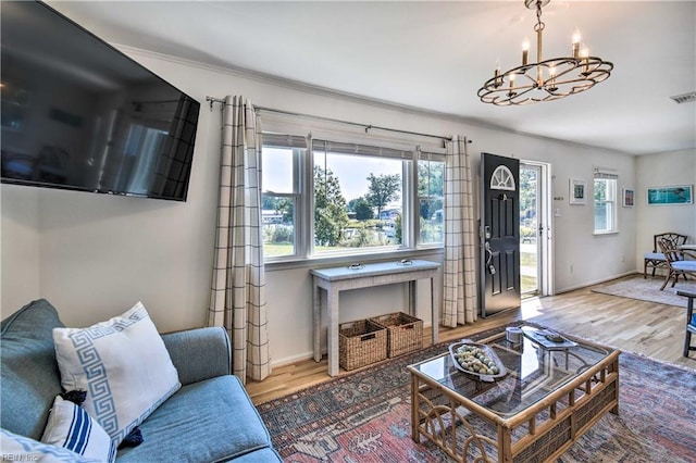 38 Callis Ln, Deltaville, VA 23043 - living area featuring baseboards, visible vents, wood finished floors, and a chandelier