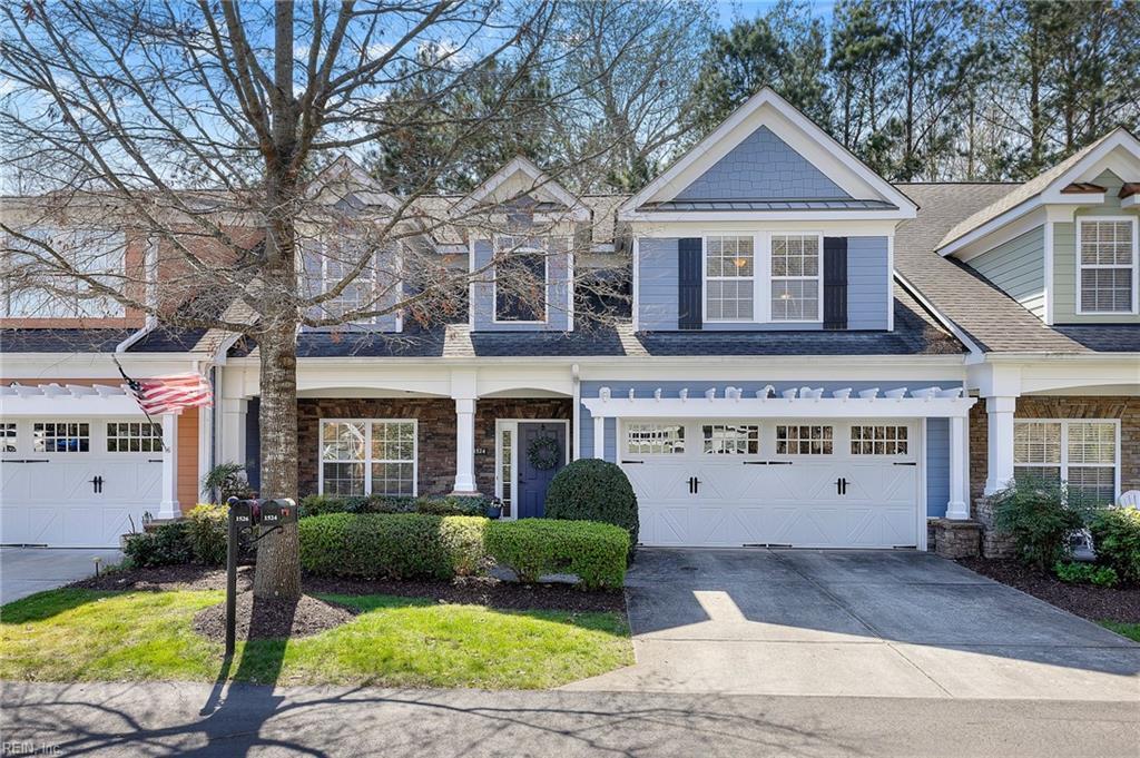 view of front of home with driveway, a shingled roof, and an attached garage