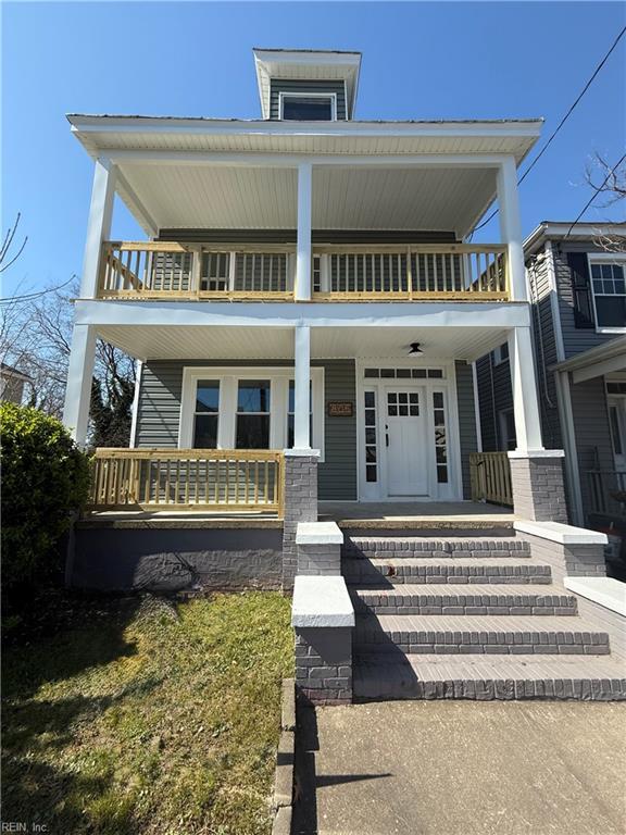 view of front of house with a balcony and covered porch