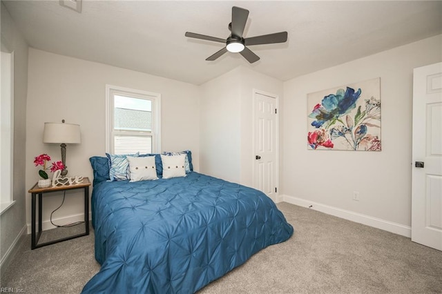carpeted bedroom featuring baseboards and a ceiling fan