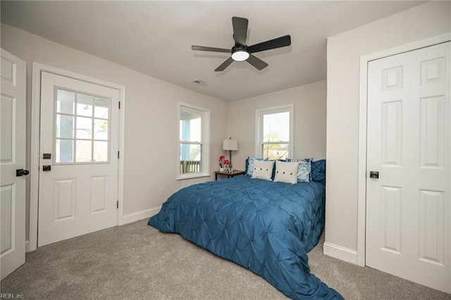 bedroom featuring baseboards, visible vents, ceiling fan, and carpet