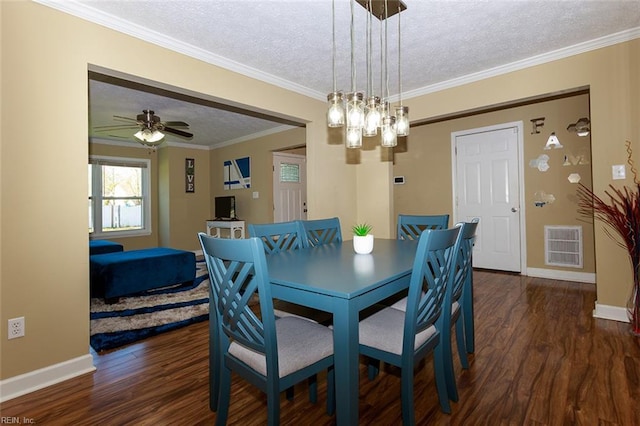 dining area with visible vents, crown molding, wood finished floors, and a textured ceiling