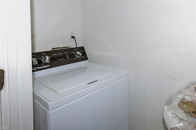 clothes washing area featuring washer / clothes dryer and laundry area