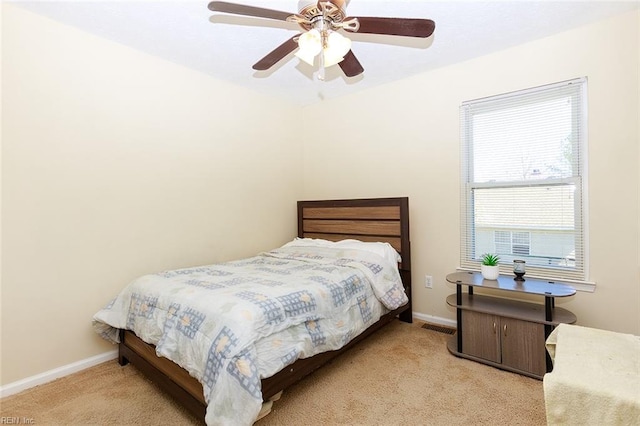 carpeted bedroom with baseboards and ceiling fan
