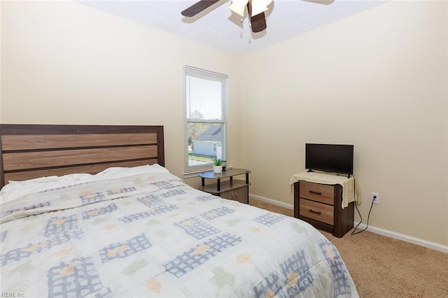 carpeted bedroom featuring baseboards and ceiling fan