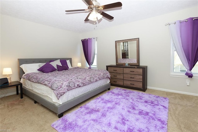 bedroom featuring baseboards, ceiling fan, and carpet flooring