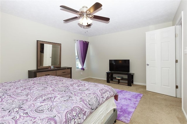 bedroom with baseboards, a ceiling fan, and light colored carpet