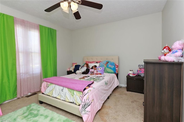 bedroom with carpet, a textured ceiling, and visible vents
