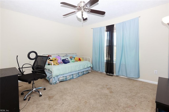 carpeted bedroom with baseboards and a ceiling fan