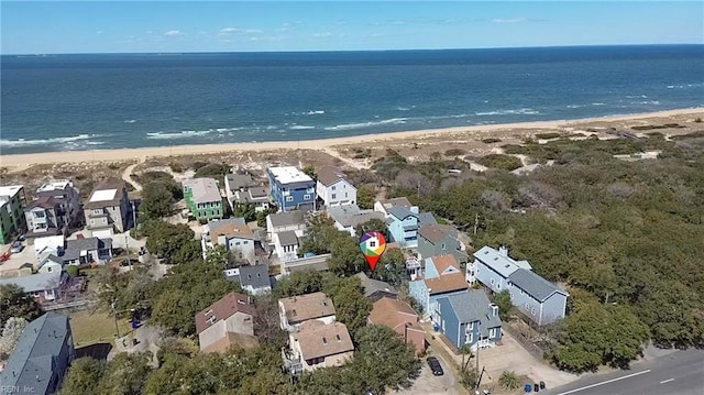 drone / aerial view with a water view, a beach view, and a residential view