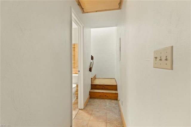 corridor featuring baseboards