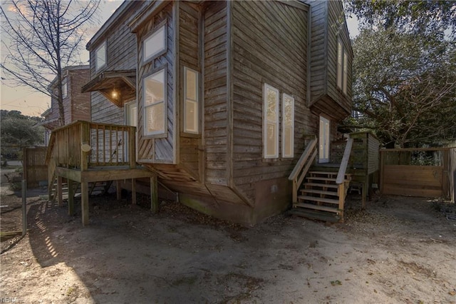 view of side of property featuring fence and crawl space