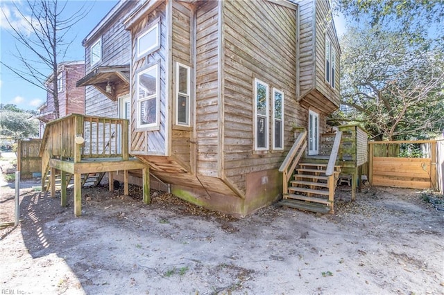 view of side of property with fence and crawl space