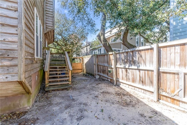 view of yard with stairs and fence