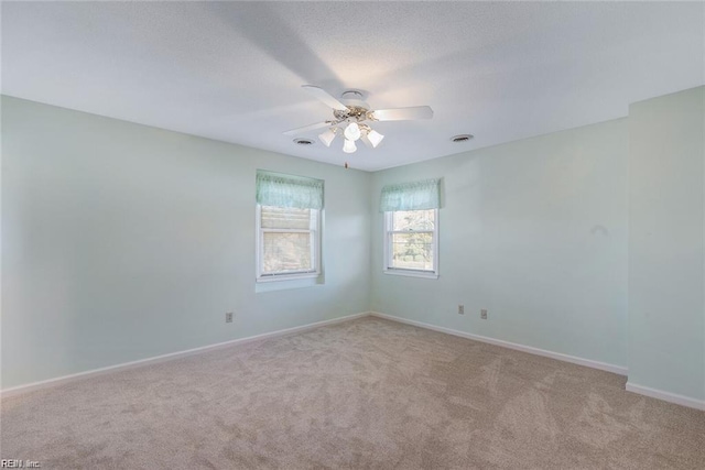 127 Freemoor Dr, Poquoson, VA 23662 - carpeted spare room featuring baseboards, visible vents, ceiling fan, and a textured ceiling