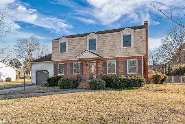127 Freemoor Dr, Poquoson, VA 23662 - view of front of property with fence, a gambrel roof, a front lawn, and a garage