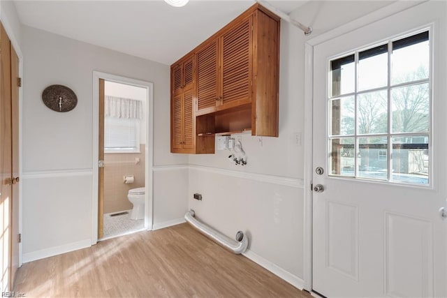 127 Freemoor Dr, Poquoson, VA 23662 - clothes washing area featuring a wealth of natural light, light wood-type flooring, cabinet space, and electric dryer hookup