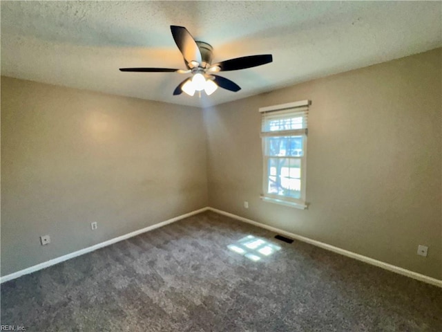 carpeted empty room with baseboards, visible vents, ceiling fan, and a textured ceiling