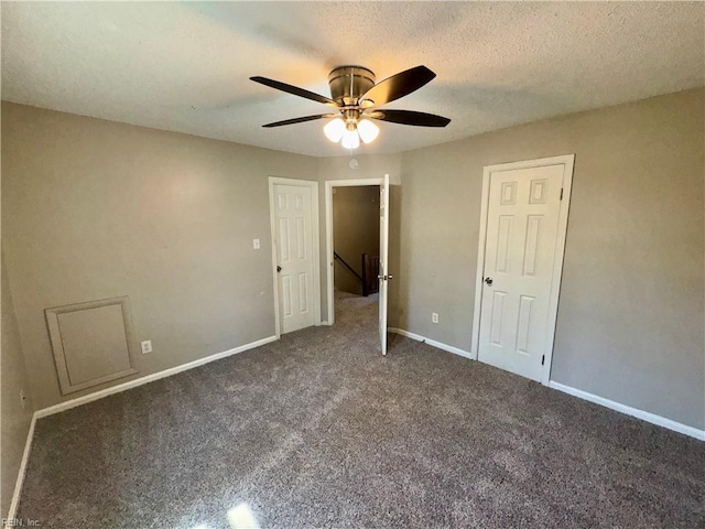 unfurnished bedroom featuring baseboards, a ceiling fan, carpet, and a textured ceiling