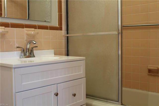 full bath featuring vanity, tile walls, and decorative backsplash